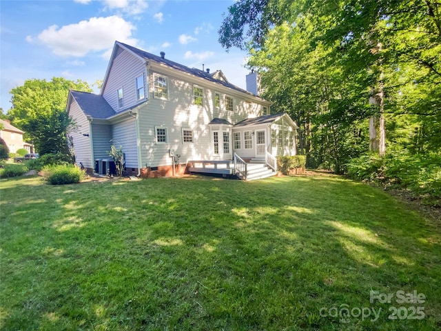 8803 Sweetwater Pl, Waxhaw, NC 28173 - rear view of property featuring a chimney, a deck, a yard, and central AC