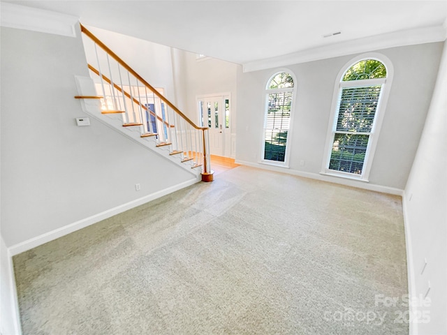 8803 Sweetwater Pl, Waxhaw, NC 28173 - carpeted foyer with stairway, baseboards, and crown molding