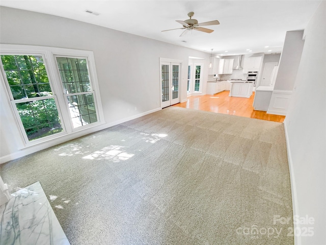 8803 Sweetwater Pl, Waxhaw, NC 28173 - unfurnished living room with ceiling fan, light carpet, baseboards, and recessed lighting