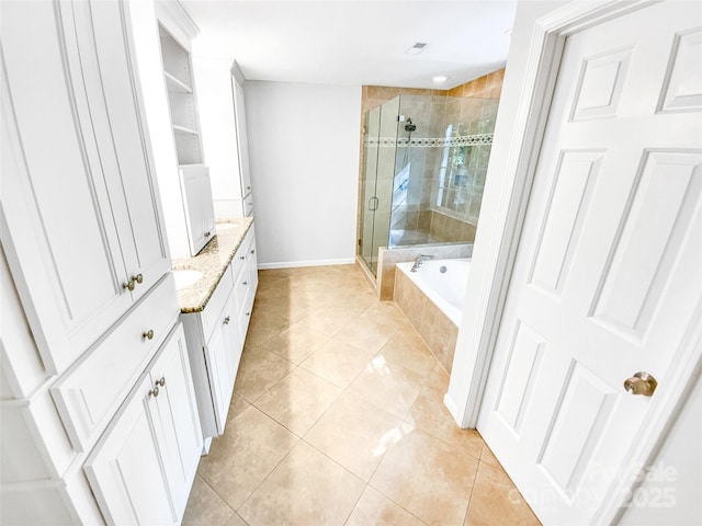 8803 Sweetwater Pl, Waxhaw, NC 28173 - full bathroom featuring a shower stall, vanity, tile patterned flooring, a garden tub, and baseboards