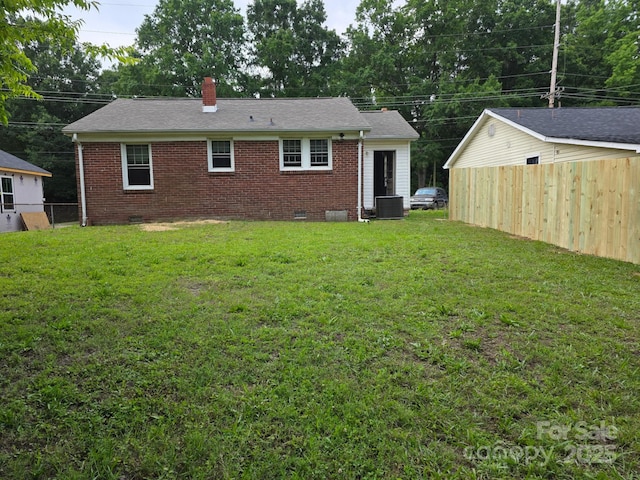 76 Sumner Ave NW, Concord, NC 28027 - rear view of house with crawl space, a chimney, brick siding, and central AC