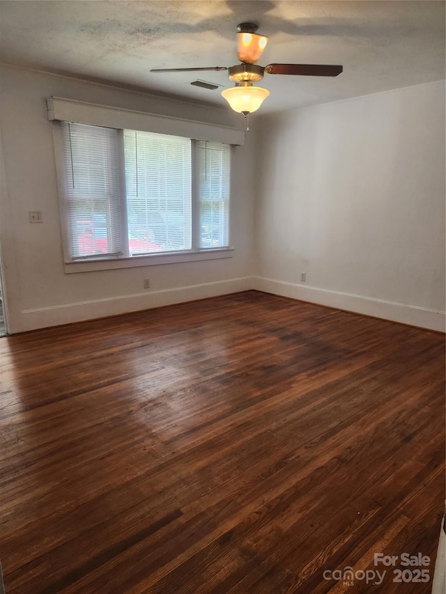 76 Sumner Ave NW, Concord, NC 28027 - unfurnished room featuring baseboards and dark wood-style flooring