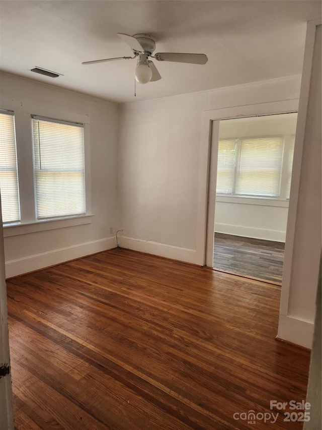 76 Sumner Ave NW, Concord, NC 28027 - spare room featuring baseboards, wood finished floors, and a ceiling fan