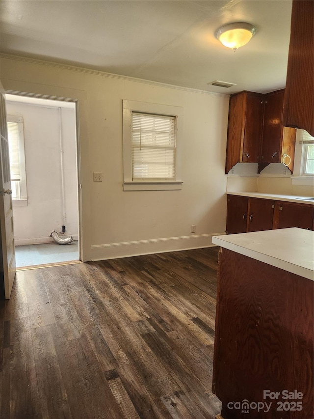 76 Sumner Ave NW, Concord, NC 28027 - kitchen featuring dark wood finished floors, light countertops, baseboards, and ornamental molding