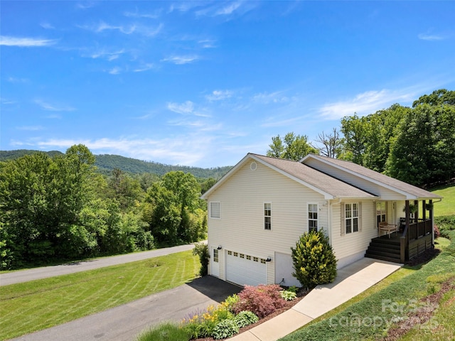 8 Rose Briar Cir, Weaverville, NC 28787 - view of home's exterior with a lawn, an attached garage, driveway, a forest view, and covered porch