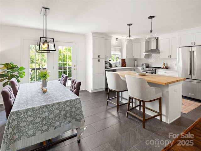 8 Rose Briar Cir, Weaverville, NC 28787 - kitchen featuring stainless steel appliances, wall chimney exhaust hood, wood counters, and plenty of natural light