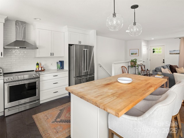 8 Rose Briar Cir, Weaverville, NC 28787 - kitchen with wall chimney exhaust hood, stainless steel appliances, backsplash, white cabinetry, and a kitchen breakfast bar