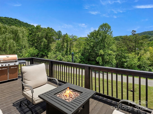 8 Rose Briar Cir, Weaverville, NC 28787 - wooden deck with an outdoor fire pit, a wooded view, area for grilling, and a yard