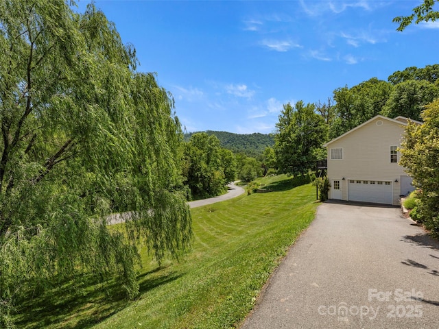 8 Rose Briar Cir, Weaverville, NC 28787 - view of side of property with a garage, asphalt driveway, a lawn, and a wooded view