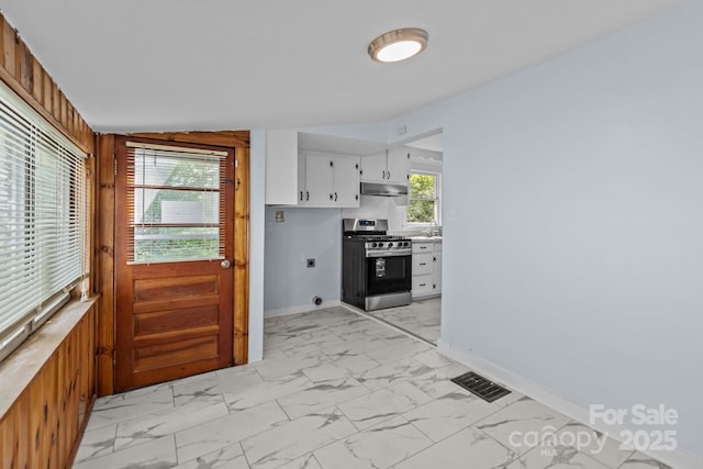 310 S Spencer Ave, Spencer, NC 28159 - kitchen with stainless steel range with gas cooktop, light marble finish floors, under cabinet range hood, white cabinetry, and light countertops