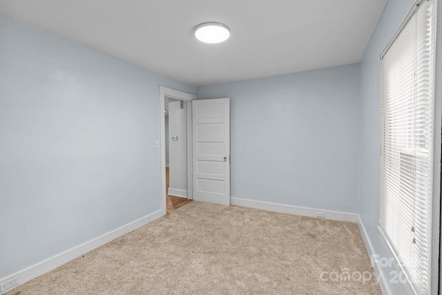310 S Spencer Ave, Spencer, NC 28159 - unfurnished bedroom with carpet flooring and multiple windows