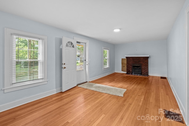 310 S Spencer Ave, Spencer, NC 28159 - foyer entrance with a fireplace and light wood-style flooring