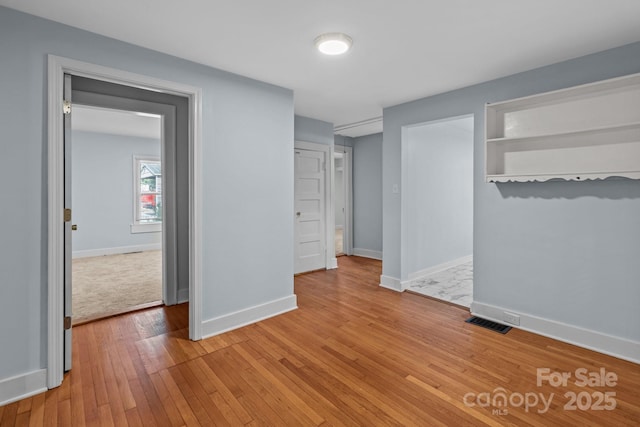 310 S Spencer Ave, Spencer, NC 28159 - unfurnished bedroom with light wood-style floors and baseboards