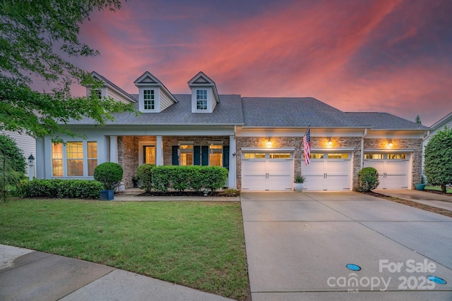 8725 Soaring Eagle Ln, Waxhaw, NC 28173 - view of front of property with brick siding, driveway, a front lawn, an attached garage, and a shingled roof