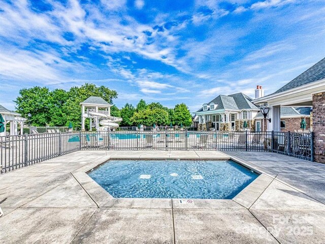 8725 Soaring Eagle Ln, Waxhaw, NC 28173 - community pool featuring a water slide and a patio area