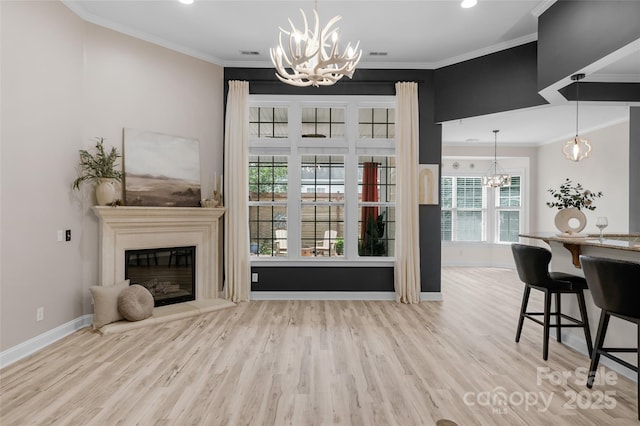 8725 Soaring Eagle Ln, Waxhaw, NC 28173 - living room with a chandelier, wood finished floors, ornamental molding, a glass covered fireplace, and recessed lighting