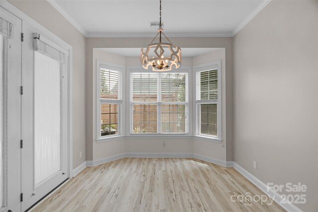 8725 Soaring Eagle Ln, Waxhaw, NC 28173 - unfurnished dining area with light wood finished floors, a chandelier, and crown molding