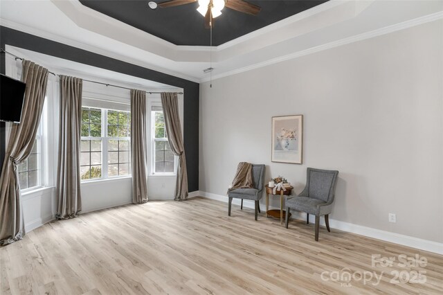 8725 Soaring Eagle Ln, Waxhaw, NC 28173 - sitting room with a tray ceiling, light wood finished floors, crown molding, and ceiling fan
