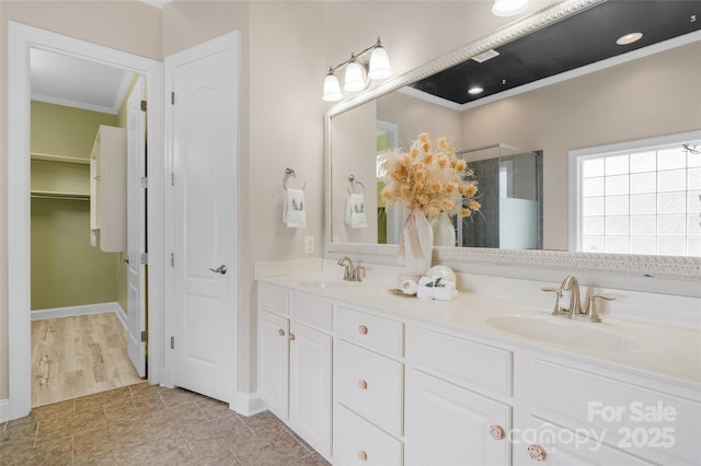 8725 Soaring Eagle Ln, Waxhaw, NC 28173 - bathroom featuring crown molding, a shower stall, double vanity, and a spacious closet