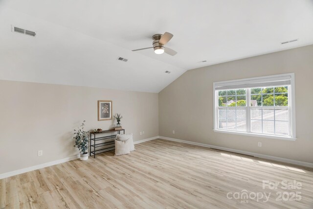 8725 Soaring Eagle Ln, Waxhaw, NC 28173 - unfurnished living room featuring ceiling fan, lofted ceiling, and light wood-style flooring