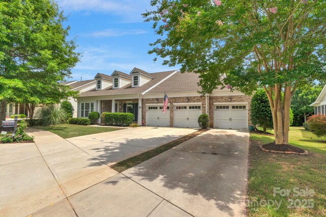 8725 Soaring Eagle Ln, Waxhaw, NC 28173 - view of front of property with driveway, brick siding, a front lawn, and a garage