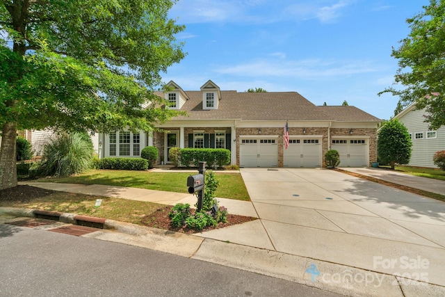 8725 Soaring Eagle Ln, Waxhaw, NC 28173 - view of front of house featuring concrete driveway, a garage, brick siding, a front lawn, and roof with shingles
