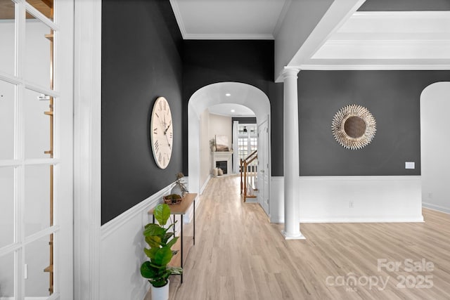 8725 Soaring Eagle Ln, Waxhaw, NC 28173 - hallway with arched walkways, light wood-type flooring, crown molding, and decorative columns