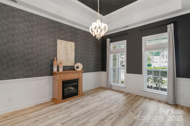 8725 Soaring Eagle Ln, Waxhaw, NC 28173 - unfurnished living room with a chandelier, wainscoting, plenty of natural light, wood finished floors, and crown molding