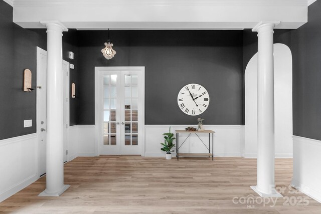 8725 Soaring Eagle Ln, Waxhaw, NC 28173 - entryway featuring light wood finished floors, french doors, ornate columns, and a wainscoted wall