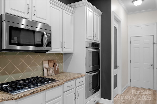 8725 Soaring Eagle Ln, Waxhaw, NC 28173 - kitchen featuring appliances with stainless steel finishes, crown molding, white cabinetry, backsplash, and light wood-style floors