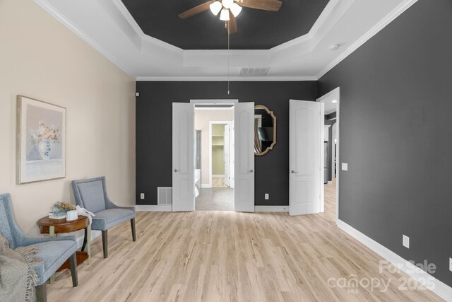 8725 Soaring Eagle Ln, Waxhaw, NC 28173 - sitting room featuring a tray ceiling, light wood-type flooring, ceiling fan, and crown molding