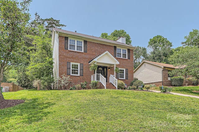 6221 Round Hill Rd, Charlotte, NC 28211 - view of front of house with a chimney, a front yard, and brick siding