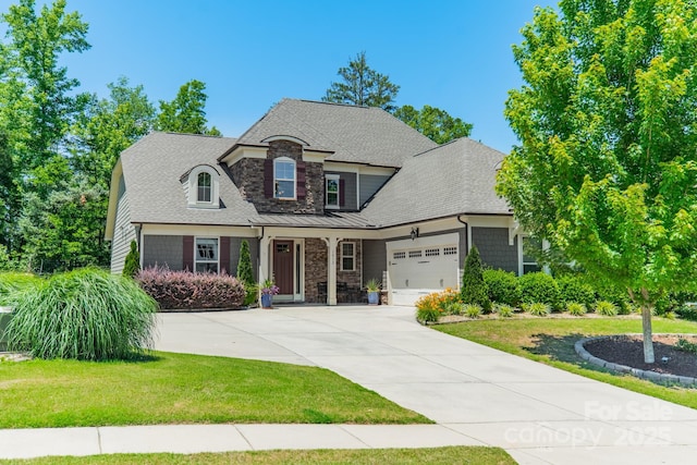 1812 Sutter Creek Dr, Waxhaw, NC 28173 - view of front of property with stone siding, an attached garage, a front yard, concrete driveway, and a shingled roof