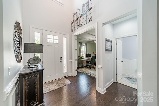 1812 Sutter Creek Dr, Waxhaw, NC 28173 - foyer with dark wood-style floors, a towering ceiling, and a wainscoted wall