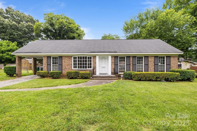 5918 Barrington Dr, Charlotte, NC 28215 - single story home with brick siding, an attached carport, driveway, and a front lawn