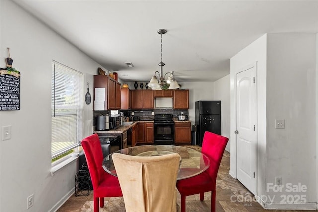 9612 Old Dowd Rd, Charlotte, NC 28214 - dining room with a chandelier and baseboards