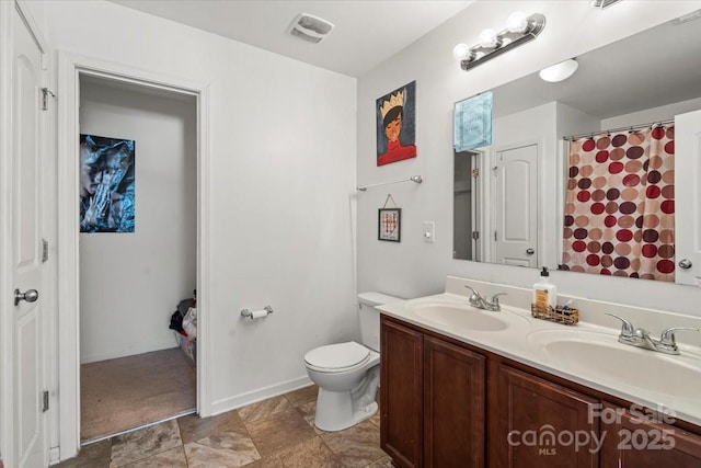 9612 Old Dowd Rd, Charlotte, NC 28214 - full bath featuring double vanity, toilet, and baseboards