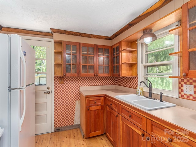 292 Cook Rd, Canton, NC 28716 - kitchen with freestanding refrigerator, a sink, open shelves, brown cabinetry, and a textured ceiling