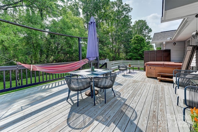 98 Driftwood Ln Unit 7, Mills River, NC 28759 - wooden terrace featuring a hot tub, outdoor dining space, and view of scattered trees
