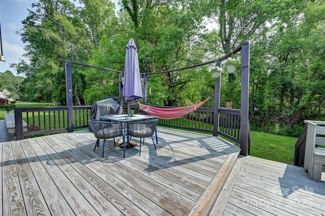 98 Driftwood Ln Unit 7, Mills River, NC 28759 - wooden deck featuring a lawn, outdoor dining space, view of scattered trees, and area for grilling