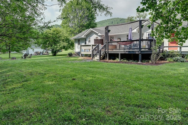 98 Driftwood Ln Unit 7, Mills River, NC 28759 - back of property featuring a deck, a lawn, and roof with shingles