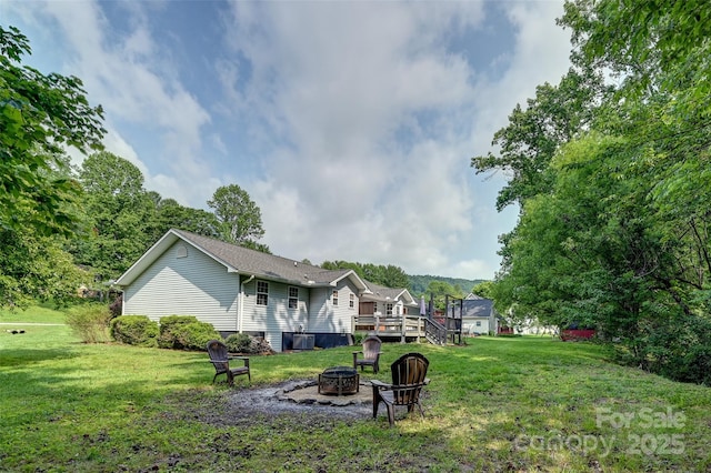98 Driftwood Ln Unit 7, Mills River, NC 28759 - view of green lawn with an outdoor fire pit, central AC, and a wooden deck