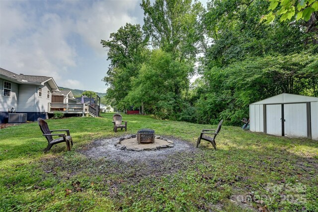 98 Driftwood Ln Unit 7, Mills River, NC 28759 - view of grassy yard with an outdoor fire pit, a deck, and central AC unit