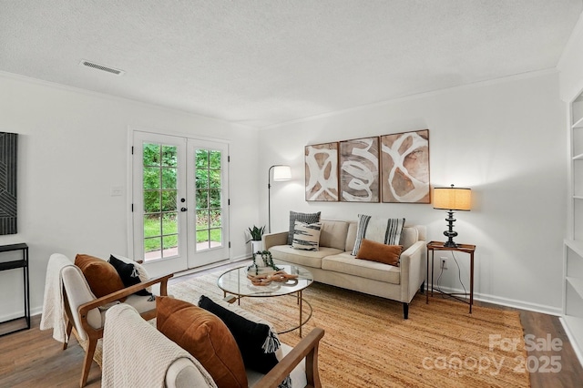 1035 Wexford Pl NW, Concord, NC 28027 - living room featuring french doors, wood finished floors, a textured ceiling, and baseboards