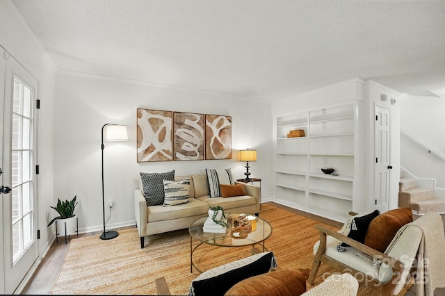 1035 Wexford Pl NW, Concord, NC 28027 - sitting room with wood finished floors, stairway, a textured ceiling, built in features, and baseboards