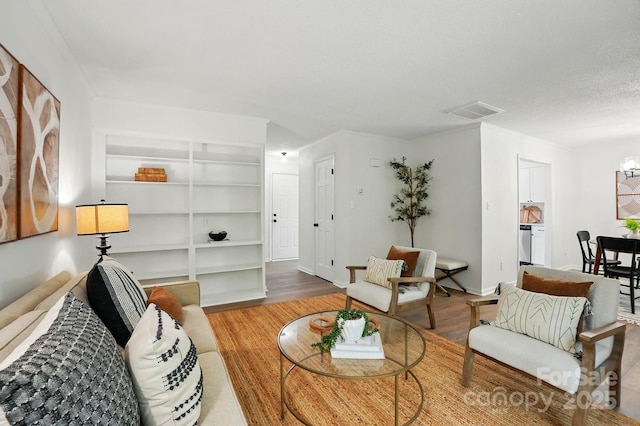 1035 Wexford Pl NW, Concord, NC 28027 - living area featuring wood finished floors, built in features, and baseboards