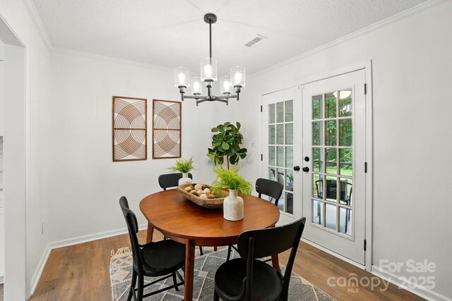 1035 Wexford Pl NW, Concord, NC 28027 - dining room featuring french doors, crown molding, a chandelier, wood finished floors, and baseboards