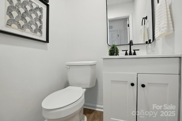 1035 Wexford Pl NW, Concord, NC 28027 - bathroom with toilet, vanity, baseboards, and wood finished floors