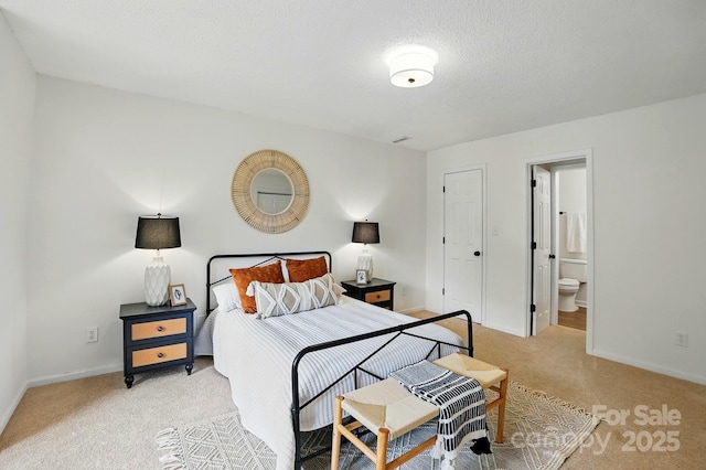 1035 Wexford Pl NW, Concord, NC 28027 - bedroom featuring light colored carpet, baseboards, and ensuite bathroom