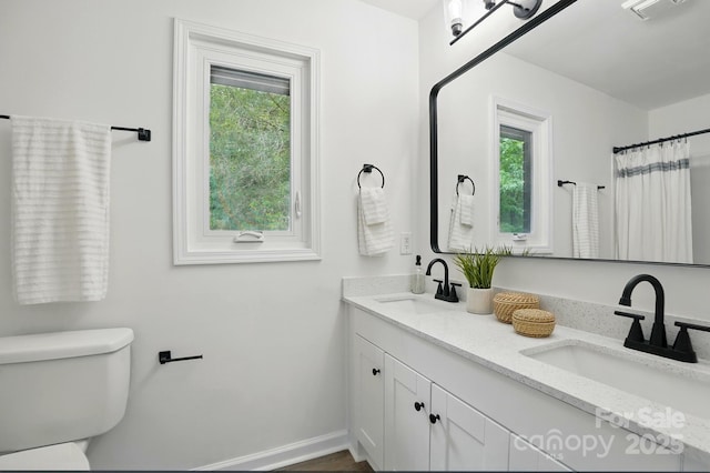 1035 Wexford Pl NW, Concord, NC 28027 - bathroom featuring double vanity, toilet, and baseboards